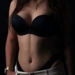 woman in black brassiere and white denim shorts