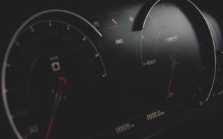 black and gray vehicle cluster panel displaying at 0